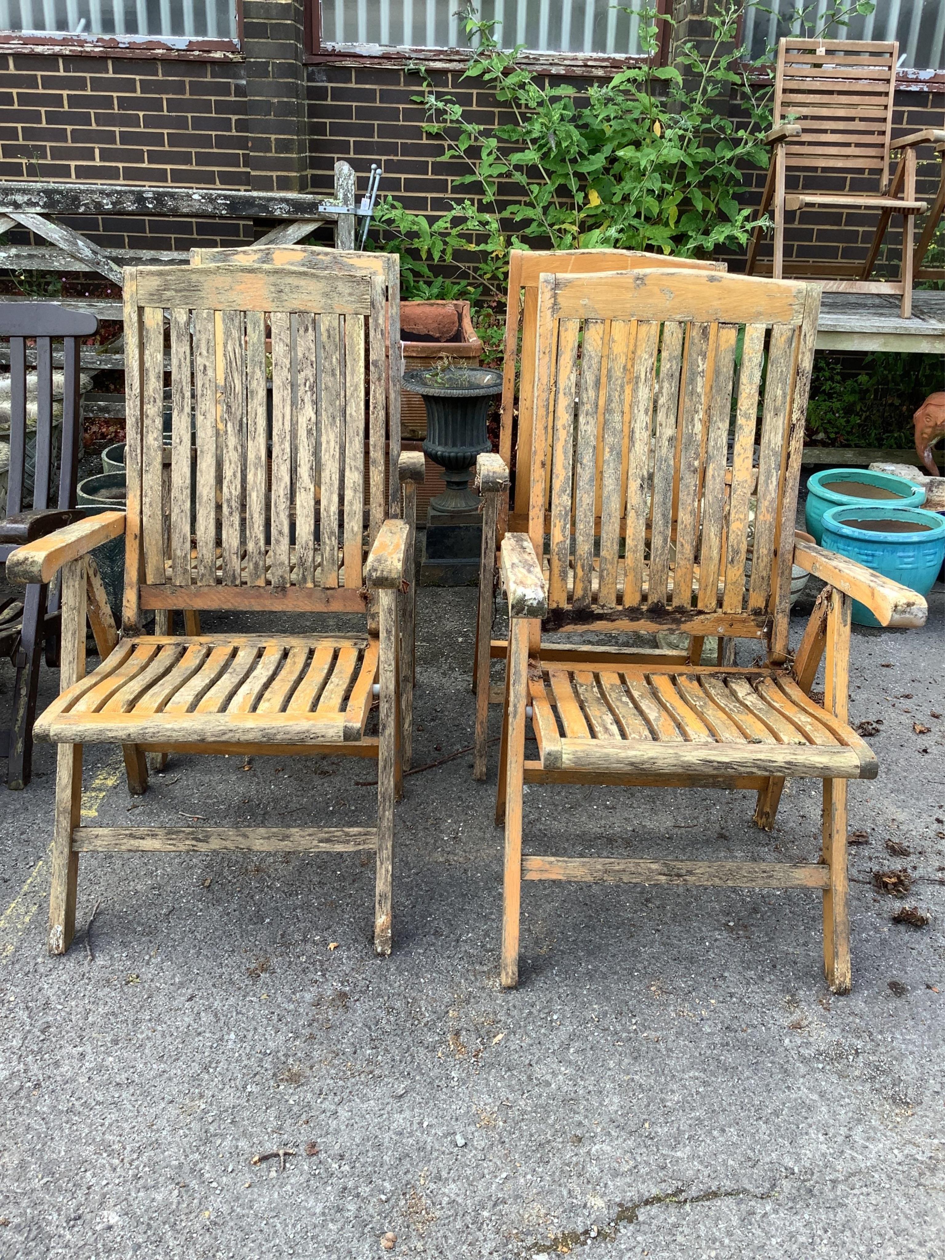 A set of four stained teak folding garden armchairs. Condition - poor